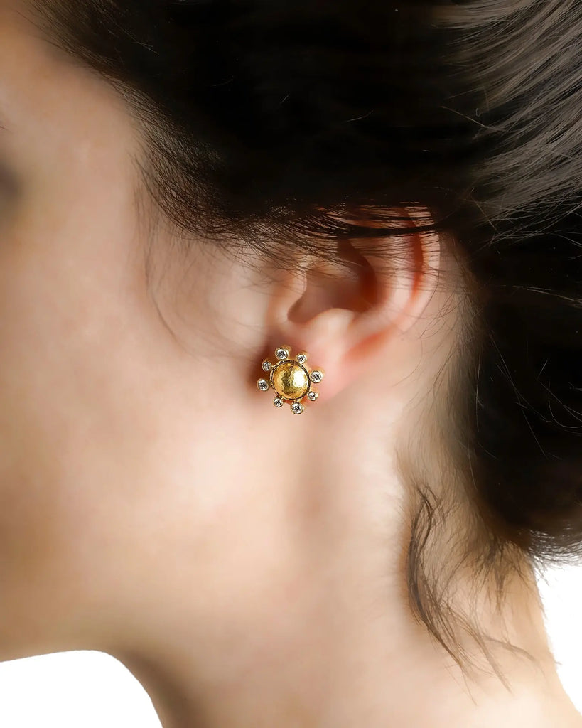 Hammered gold dome and diamond earring shown worn on ear