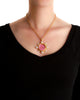 Pink Venetian glass Cupid Riding a Lion intaglio and pearl pendant shown worn on a necklace